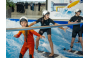 Thumbnaileinige Kinder surfen gerade das erste Mal auf der stehenden Welle der Jochen Schweizer Arena