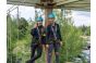 ThumbnailOutdoor-Kletterabenteuer in der Jochen Schweizer Arena: Zwei Frauen mit Helm und Sicherheitsausrüstung stehen lachend auf der Plattform des Hochseilgartens.